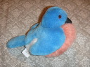 A stuffed blue and pink bird